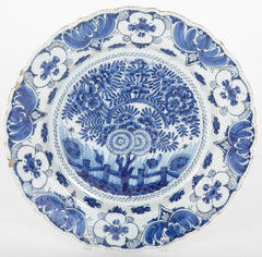 A Delft Blue & White Charger Depicting Blossoms from a Rock
