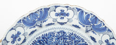A Delft Blue & White Charger Depicting Blossoms from a Rock