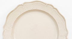 A Salt Glazed Stoneware Charger with Serpentine Border and Dimpled Margin