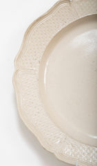 A Salt Glazed Stoneware Charger with Serpentine Border and Dimpled Margin