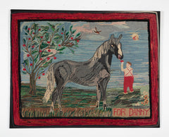 An Exceptional American Hooked Rug Depicting a Boy Feeding an Apple to a Horse