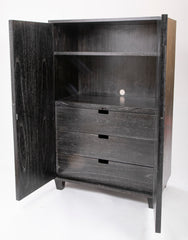 A Two Door Ebonized and Cerused Cabinet