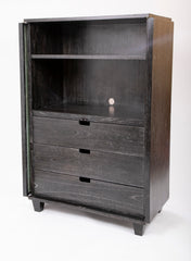 A Two Door Ebonized and Cerused Cabinet
