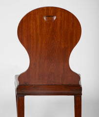 A Pair of Late Georgian Mahogany and Polychrome Hall Chairs