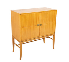 A Tommi Parzinger cabinet with 3 interior drawers