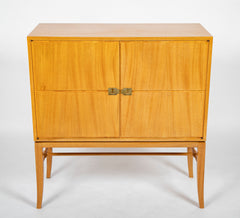 A Tommi Parzinger cabinet with 3 interior drawers