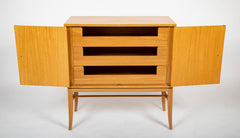 A Tommi Parzinger cabinet with 3 interior drawers