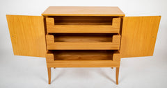 A Tommi Parzinger cabinet with 3 interior drawers