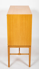 A Tommi Parzinger cabinet with 3 interior drawers