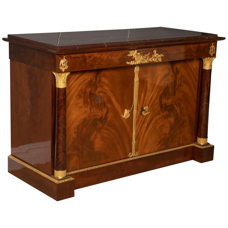 A Molitor French Empire Flame Mahogany and Gilt Bronze Commode with Rouge Griotte