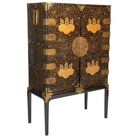 A Large Japanese Black and Gold Lacquered Cabinet on Stand with Gilt Mounts