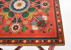 A Red Norwegian Table with Colorful Floral Painted Decoration