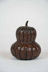 A Japanese Repousse Copper Scroll Weight in the Form of a Gourd