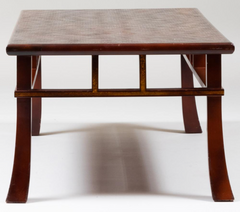 A Japanese style coffee table with rusticated top